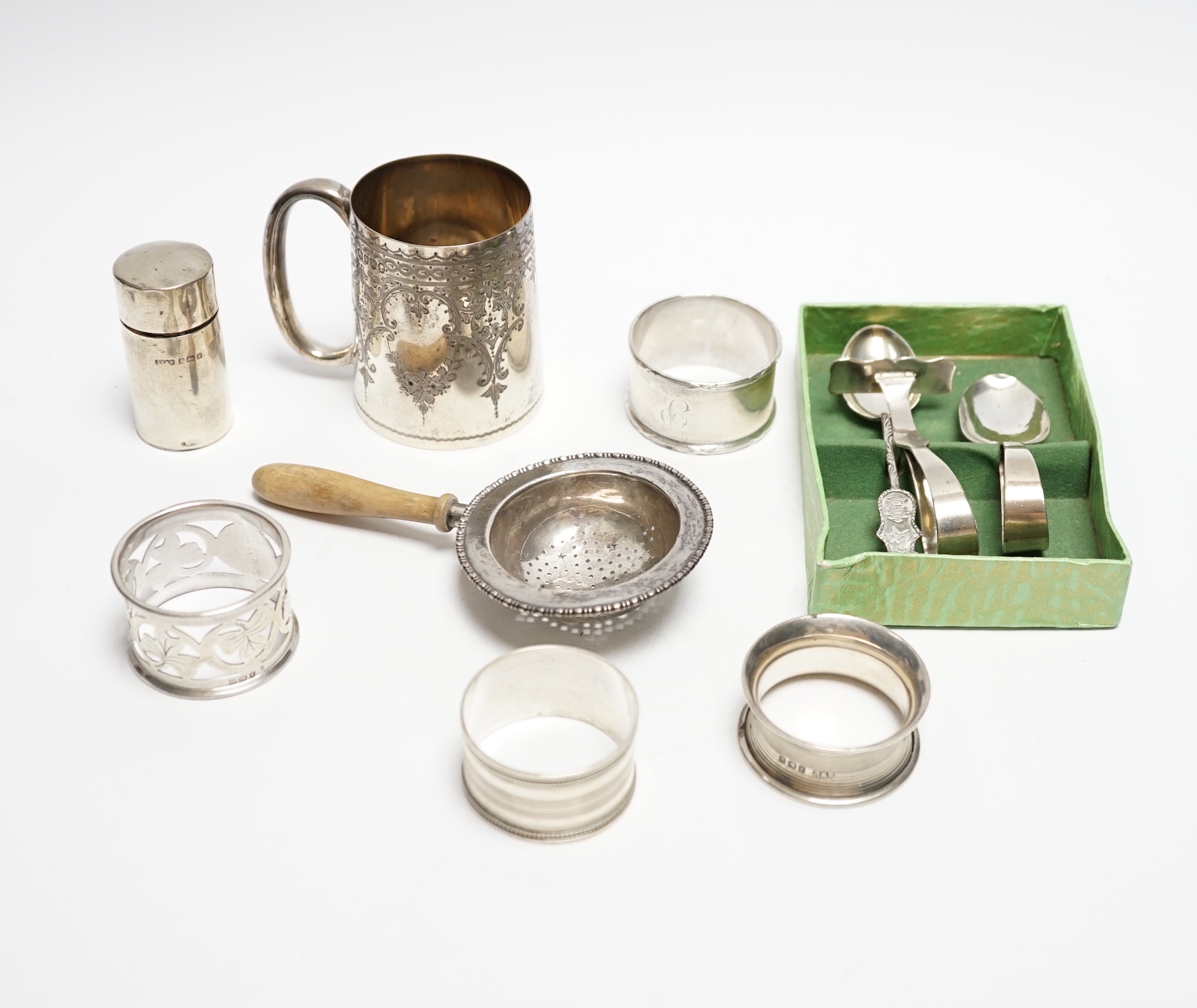 A Victorian engraved silver christening mug, Charles Stuart Harris, London, 1887, 71mm and other items including silver scent bottle, napkin rings and tea strainer.